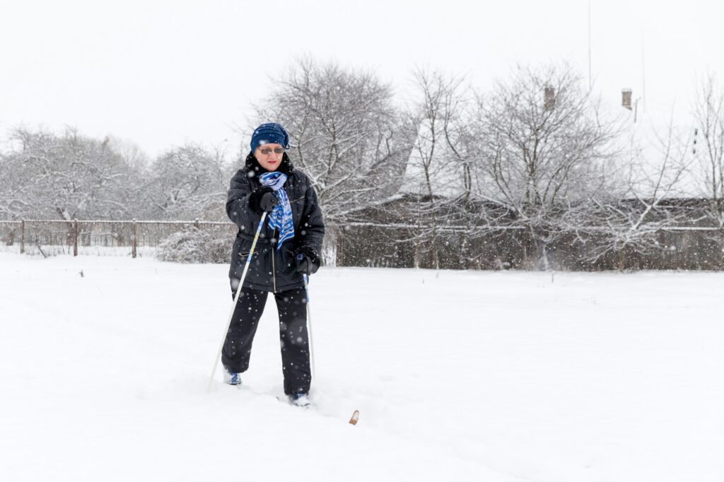 Baby boomer woman stays active in winter cross skiing