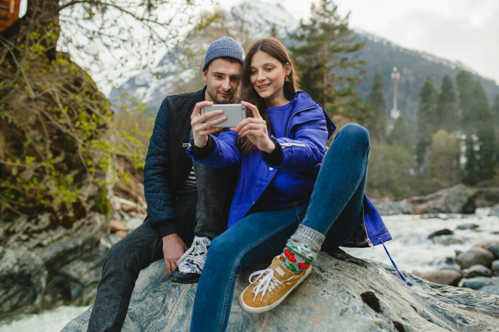 young hipster couple in love on winter vacation in mountains